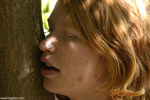 Redheaded babe attached to a tree gets abused by a stranger in the park | Фото 20