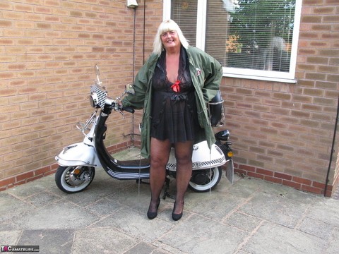 Overweight blonde Chrissy Uk strips down to her stockings next to her scooter | Фото 2