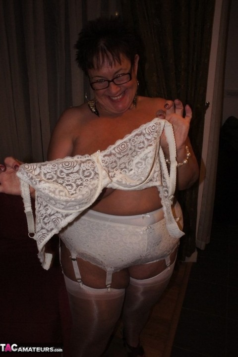 Older BBW Warm Sweet Honey sets her large tits free in hose and girdle panties | Фото 9