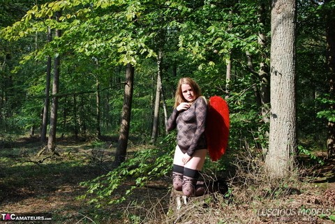 Redheaded amateur models lingerie and angel wings plus stockings in the woods | Фото 16