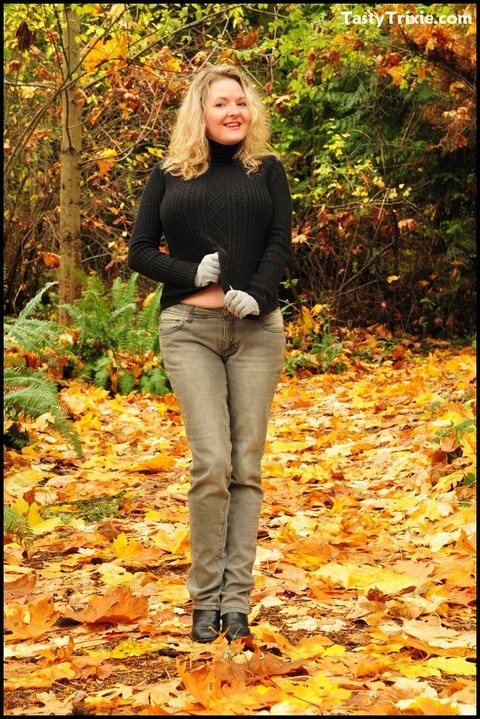 Mature woman Tasty Trixie exposes tits and panties amid fallen leaves