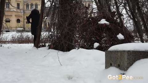 Short taken girl Vika squats for a piss on snow-covered ground in the city | Фото 15