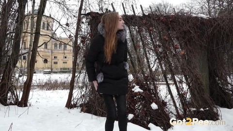 Short taken girl Vika squats for a piss on snow-covered ground in the city | Фото 2