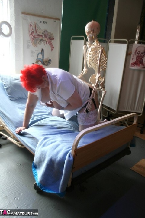 Slutty mature nurse in white stockings gets toyed up by a skeleton | Фото 20