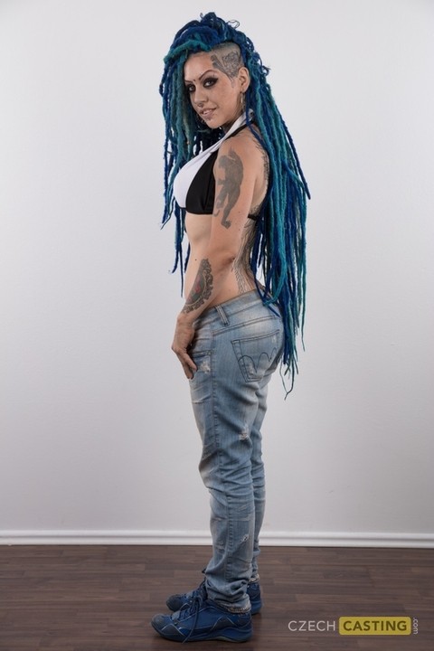 Punk girl with a headful of dyed dreads stands naked in her modelling debut