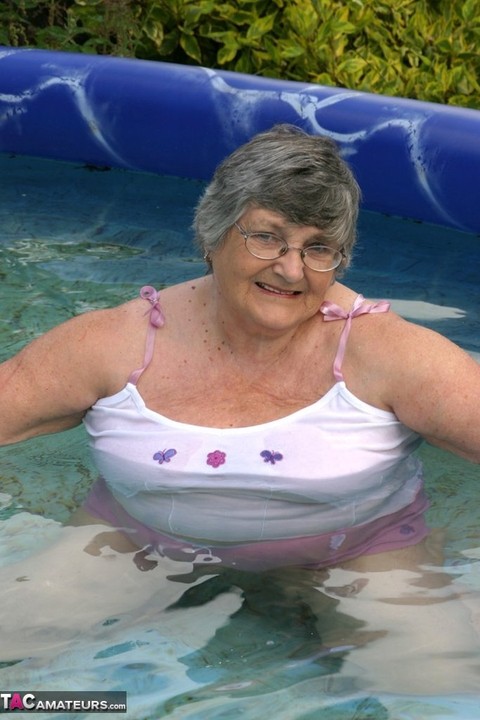 Overweight UK nan Grandma Libby exposes her boobs in a backyard swimming pool