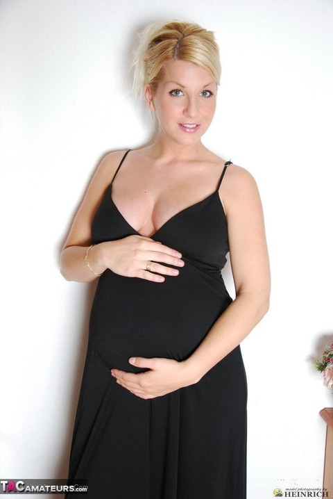 Pregnant blonde beauty drops gown to reveal her swollen belly & full milkers