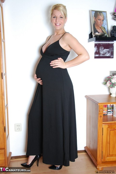 Pregnant blonde beauty drops gown to reveal her swollen belly & full milkers | Фото 5