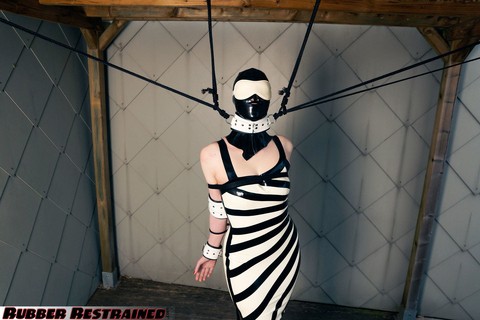 Latex attired woman is restrained in a zebra inspired dress and hood | Фото 8