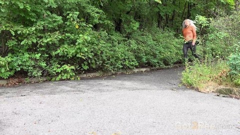 Platinum blonde squats for a piss on a paved road in the country | Фото 1