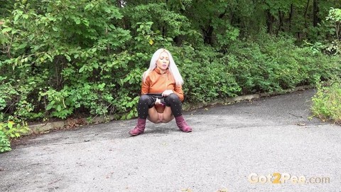 Platinum blonde squats for a piss on a paved road in the country | Фото 3