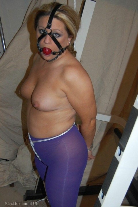 Chubby blonde sports a ball gag while topless & restrained in purple pantyhose | Фото 4