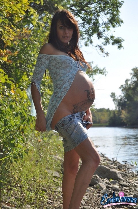 Solo girl Brianna exposes her pregnant belly on rocky shore beside a river | Фото 4