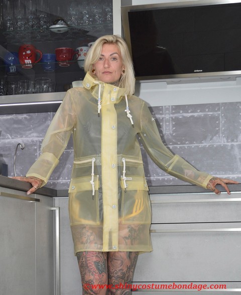 Tattooed blonde Miss Francine models barefoot in a raincoat over rubber wear | Фото 12