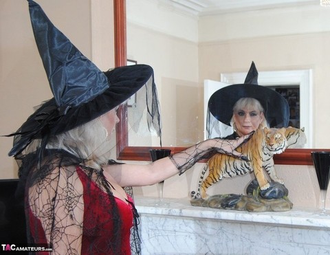 Middle-aged platinum blonde Dimonty models lingerie and a witch's hat | Фото 1