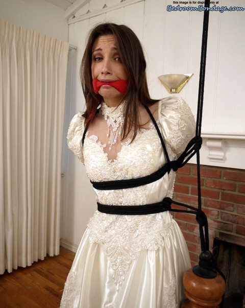 Brunette bride Celeste Star is ballgagged and tied up in her wedding dress | Фото 4