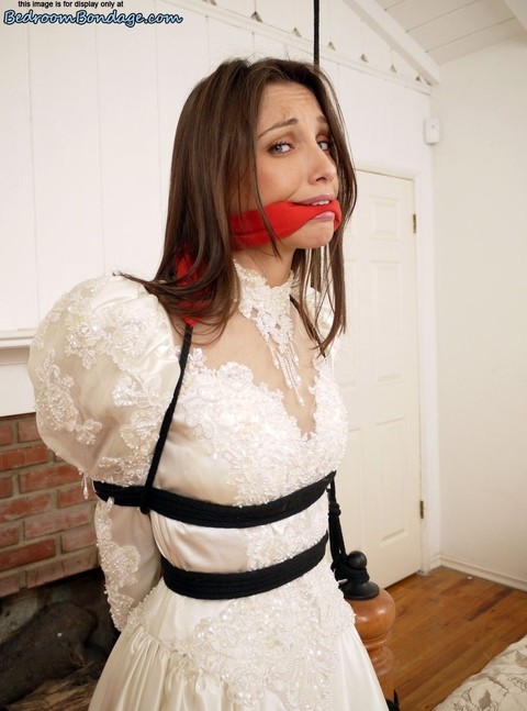 Brunette bride Celeste Star is ballgagged and tied up in her wedding dress | Фото 6