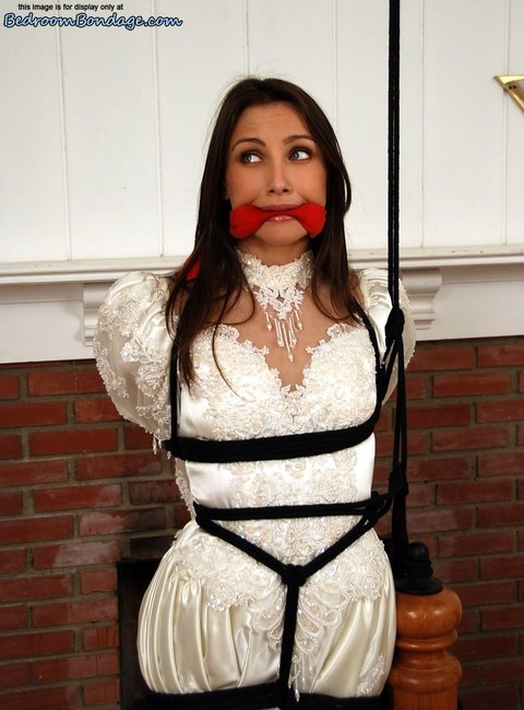 Brunette bride Celeste Star is ballgagged and tied up in her wedding dress | Фото 9