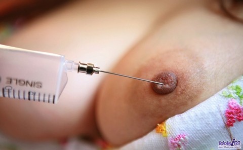 Kinky Japanese nurse Namie Koshino pokes her naked body parts with a needle | Фото 13