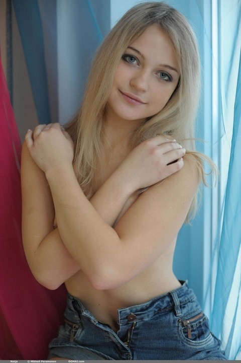 Sweet blonde teen Natja gets naked by a window in a casual manner | Фото 4