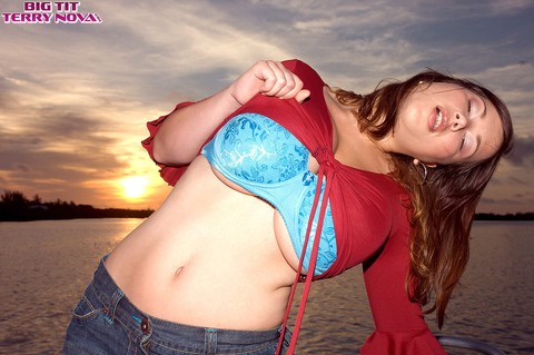 Brunette babe in skirt Terry Nova lets out her magnificent bosom on a boat | Фото 3