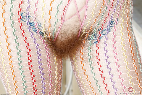 Curly older redhead Leona parting hairy vagina in bodystocking