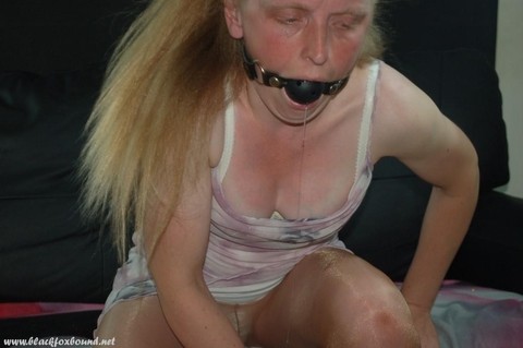 Caucasian female drools while sporting a ballgag in hose and heels | Фото 7