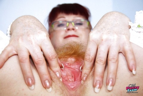 Filthy redhead mature nurse in glasses toying her hairy muff