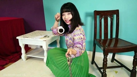 Close Asian chick removes ankle cuffs after being chained to a chair | Фото 14