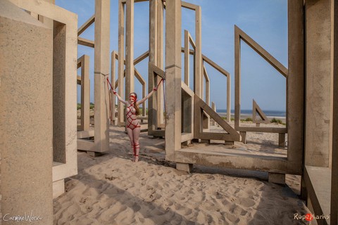 White girl Carmine Worx is tied with ropes to construction beams on a beach | Фото 15