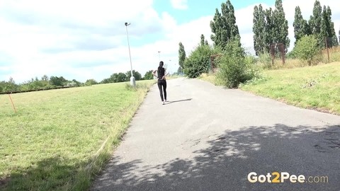 Brunette female Luu pulls down leather pants for a pee on a pave roadway | Фото 14