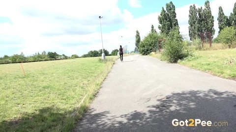 Brunette female Luu pulls down leather pants for a pee on a pave roadway | Фото 15