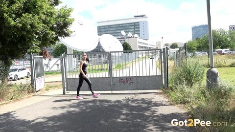 Brunette female Luu pulls down leather pants for a pee on a pave roadway | Фото 2