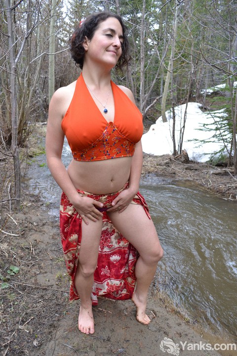 Busty amateur pets her beaver while bent over next to a brook in the woods | Фото 2