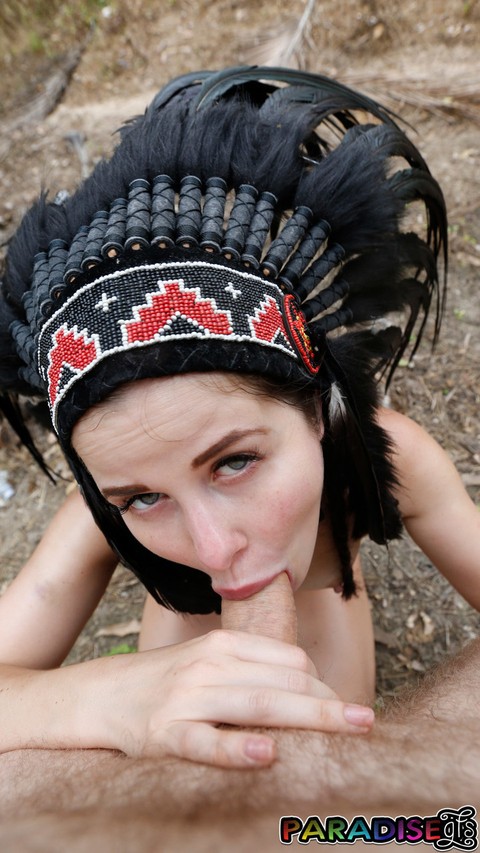 Naked gf Cassie Fire wears a headdress during a POV blowjob in the woods