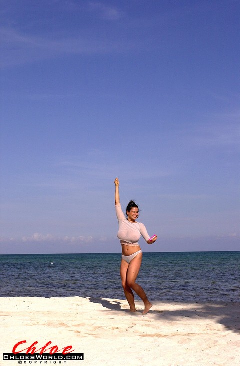 Super busty Chloe Vevrier letting her massive big tits hang loose at the beach | Фото 1