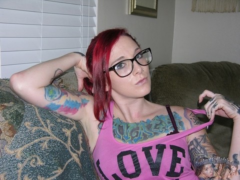 Tattooed redhead Lola takes off her glasses and clothes for her first nudes