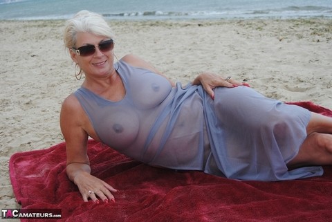 Mature platinum blonde Dimonty models at the beach in see through clothing | Фото 12