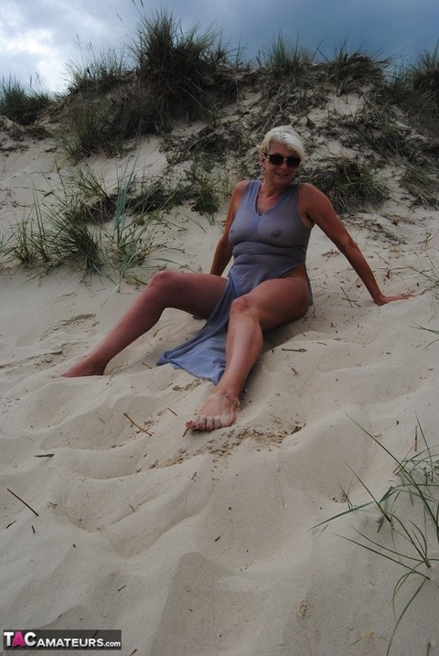 Mature platinum blonde Dimonty models at the beach in see through clothing | Фото 6