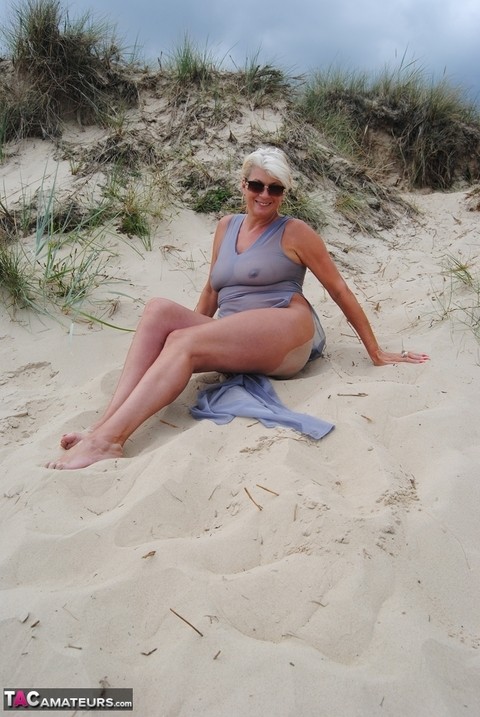 Mature platinum blonde Dimonty models at the beach in see through clothing | Фото 7