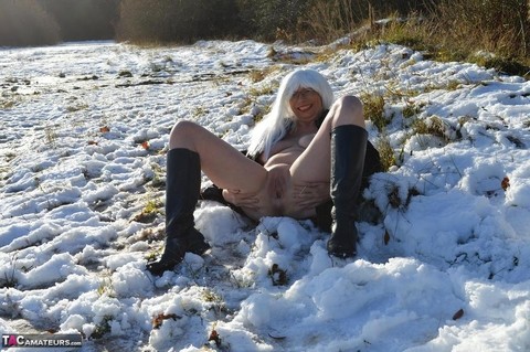 Mature platinum blonde gets naked on snow-covered ground in black boots | Фото 17