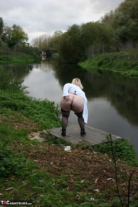 Obese blonde Lexie Cummings exposes herself in a rural setting