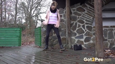 White girl Cynthia Vellons takes a piss on a deck behind a stone structure | Фото 14