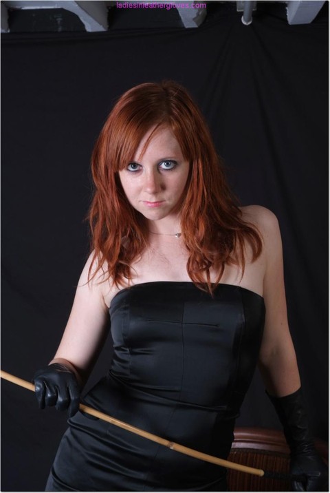 Sexy redhead flexes a cane before touching her tight slit with leather gloves | Фото 15