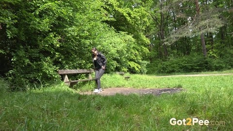 Brunette chick Barbe takes a piss on a bench beside a walking path | Фото 1