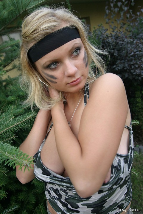 Blonde chick Malina May shows her nice tits in a backyard while in camouflage | Фото 14