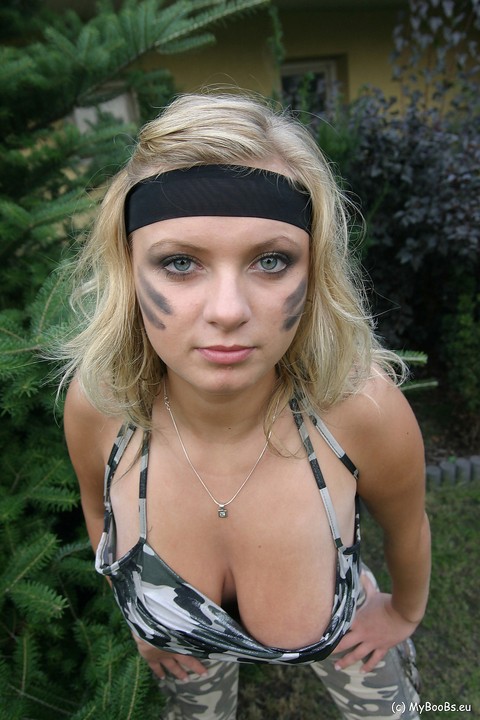 Blonde chick Malina May shows her nice tits in a backyard while in camouflage | Фото 4