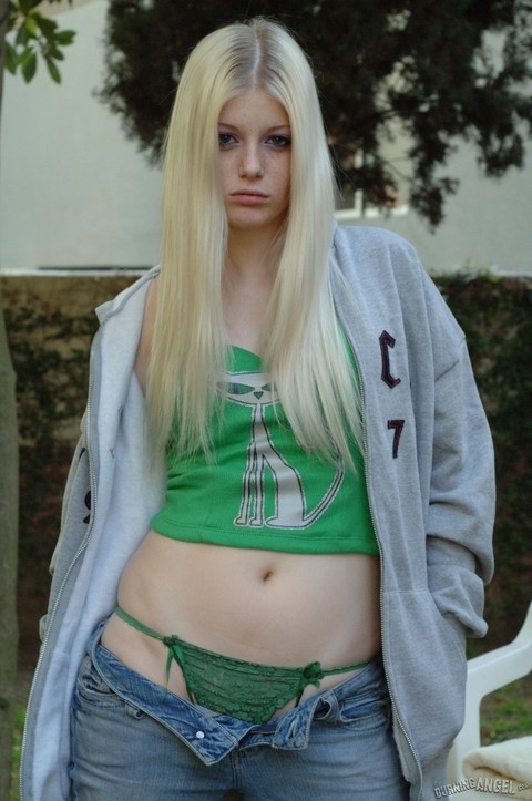 Pale blonde teen peels her green threads outdoors to reveal firm tits & finger