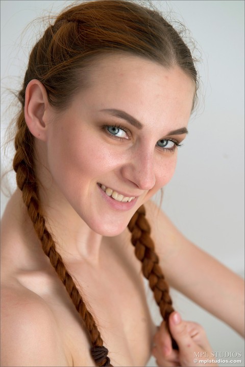 Slim redhead wears her hair in braided pigtails while modeling in the nude | Фото 5