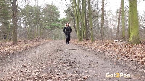 Solo girl Natasha Ink squats for a pee on a dirt road in glasses and a coat | Фото 1